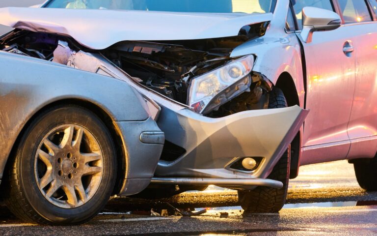Two damaged vehicles after a car accident with front-end collision damage
