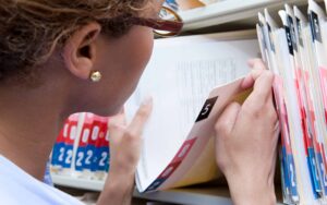 Woman reviewing medical records and documents for a personal injury claim