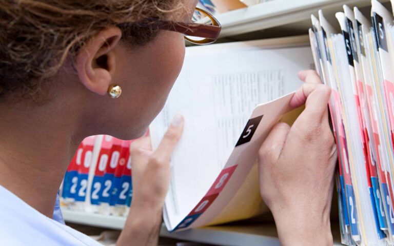 Woman reviewing medical records and documents for a personal injury claim
